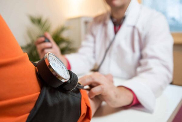 High Blood Pressure. Dr taking patient's blood pressure.