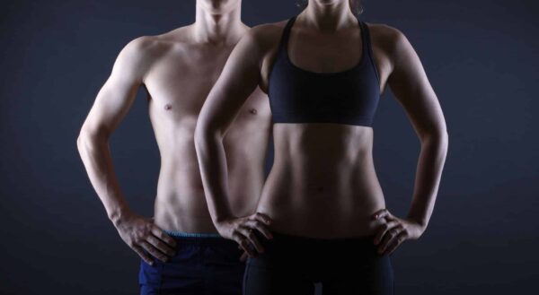 The Key to Weight Loss. Man and woman's fit torso.