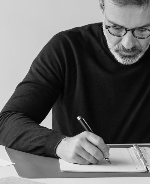 man writing on notepad